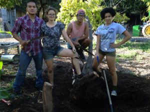 Students posing with shovels after working on the Farm 